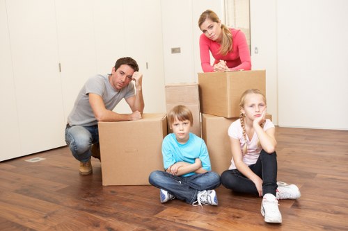 Moving team loading furniture into a van for house removals in Morden
